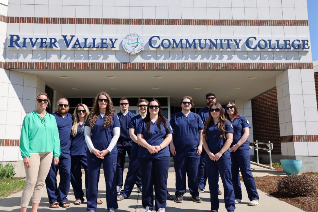 Radiologic Technology Students standing in front of the RVCC building wearing sunglasses on a sunny day.